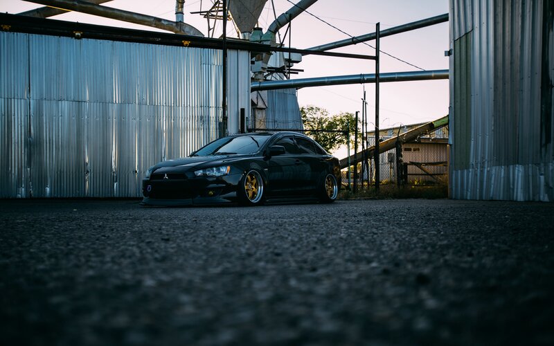 Black Modified Car — Dramatic, Sunset, Photograph, Industrial Building