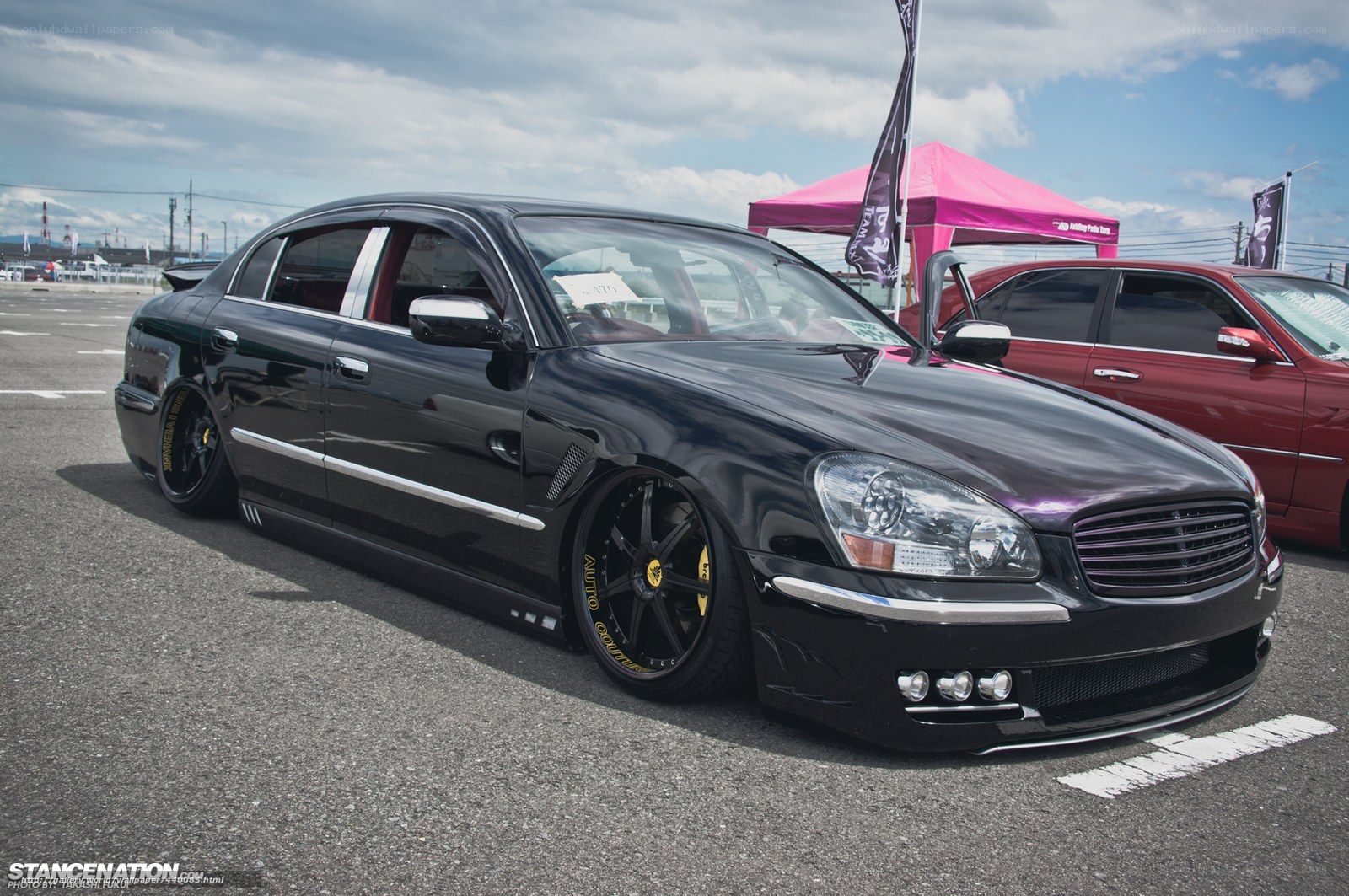 black modified sedan at car show