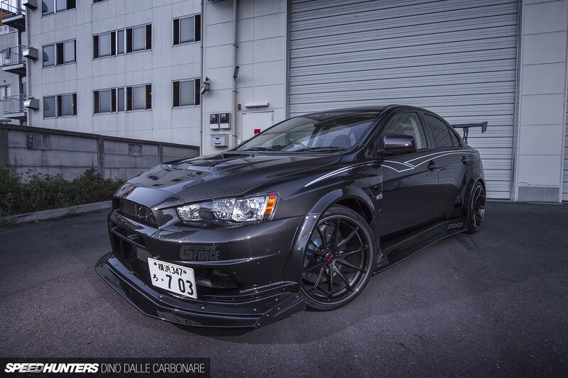 Black Modified Sedan — Dramatic, Photograph, Building