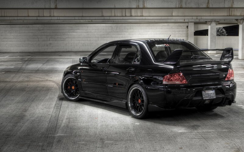 Black Modified Sedan — Dramatic, Photograph, Tire Marks, Concrete Floor