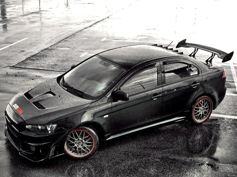 Black Modified Sedan — Dramatic, Photograph, Wet Pavement, Rear Wing