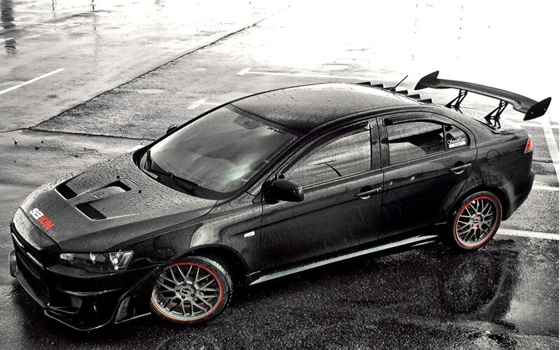 Black Modified Sedan — Dramatic, Photograph, Wet Pavement