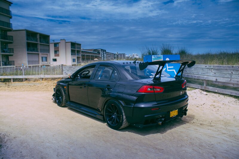 Black Modified Sedan — Dramatic, Sunset, Photograph, Apartment Buildings