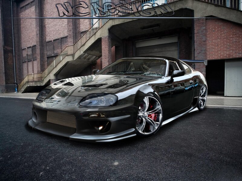 Black Modified Sports Car — Dramatic, Photograph, Brick Building