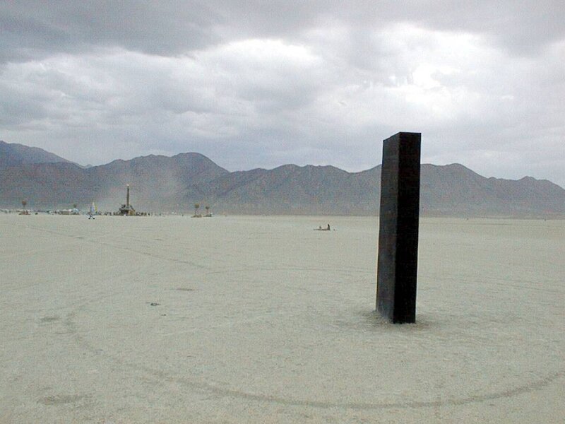 Black monolith in desert