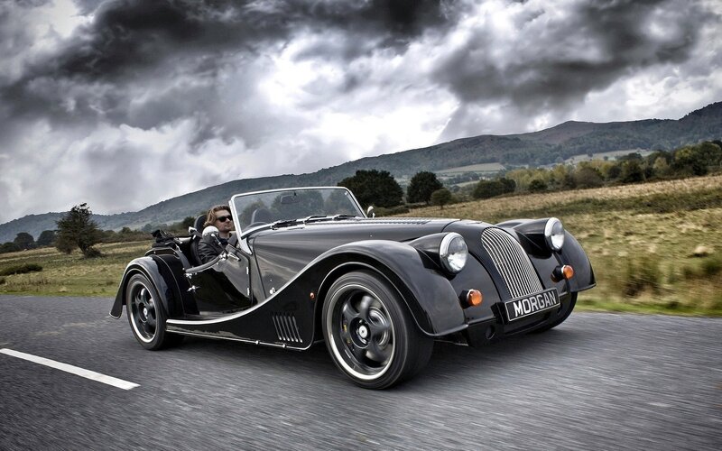 Black Morgan car on country road