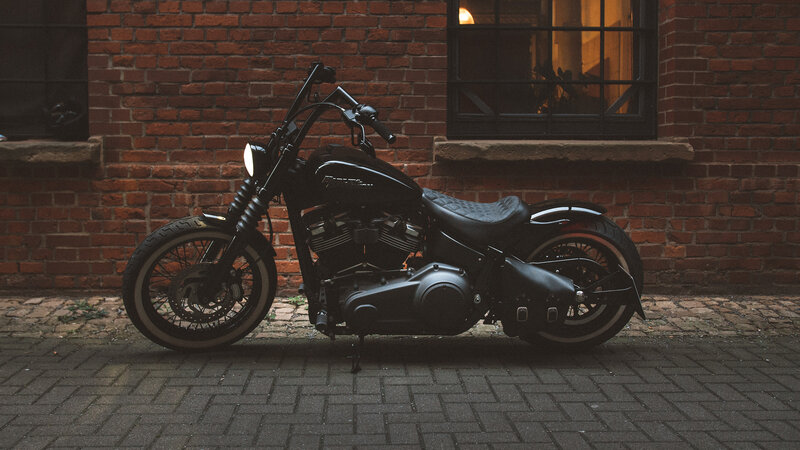 Black Motorcycle Against Brick Wall