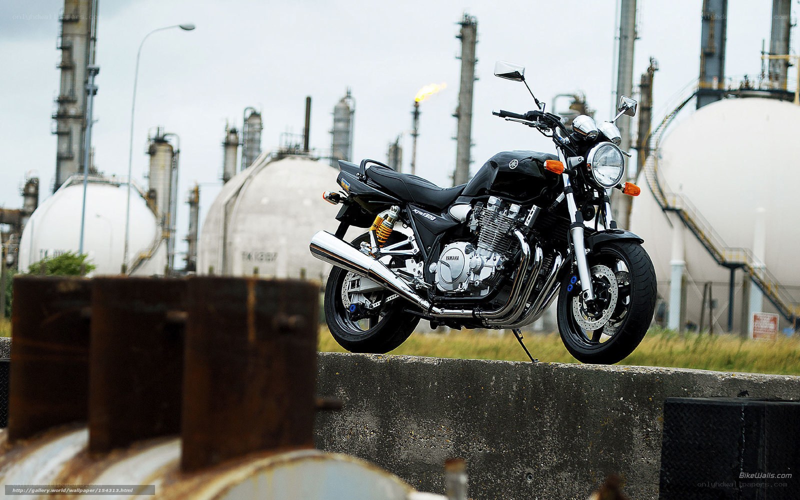 Black motorcycle at industrial site