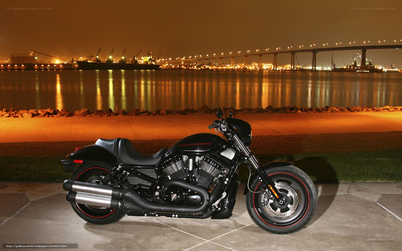 Black motorcycle at night by the water