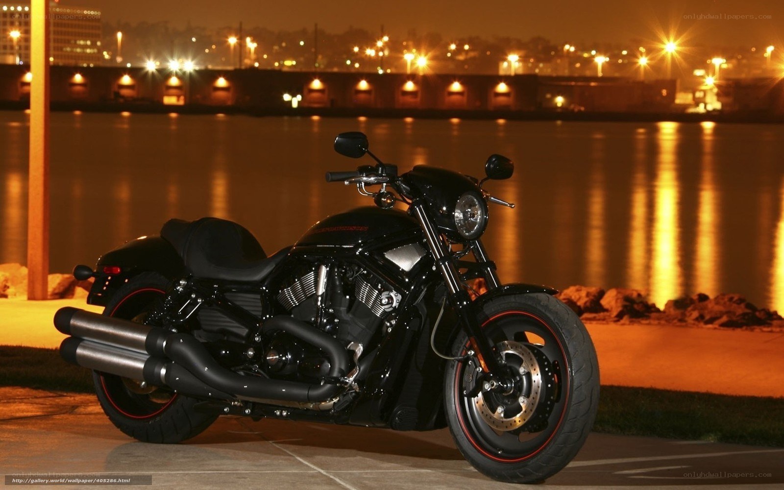 Black motorcycle at night by water