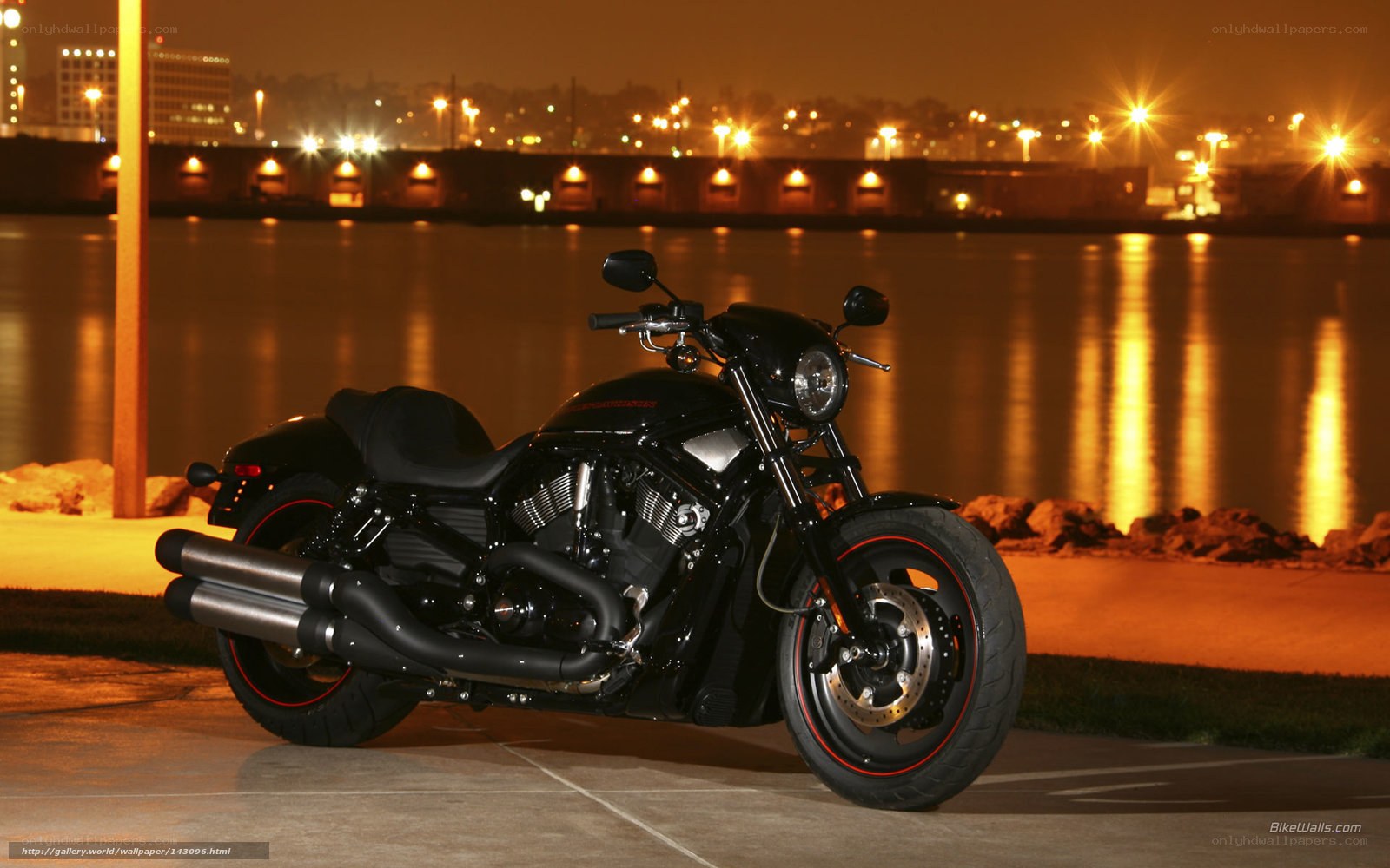 Black motorcycle at night by water
