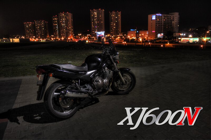 Black Motorcycle at Night — Dramatic, Photograph, City Skyline