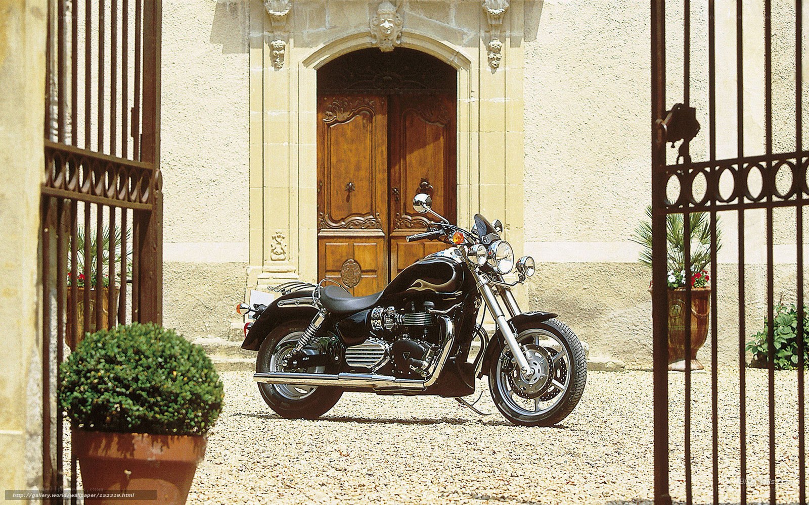 Black motorcycle at stone gate