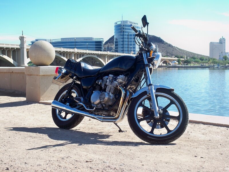 Black motorcycle by the water