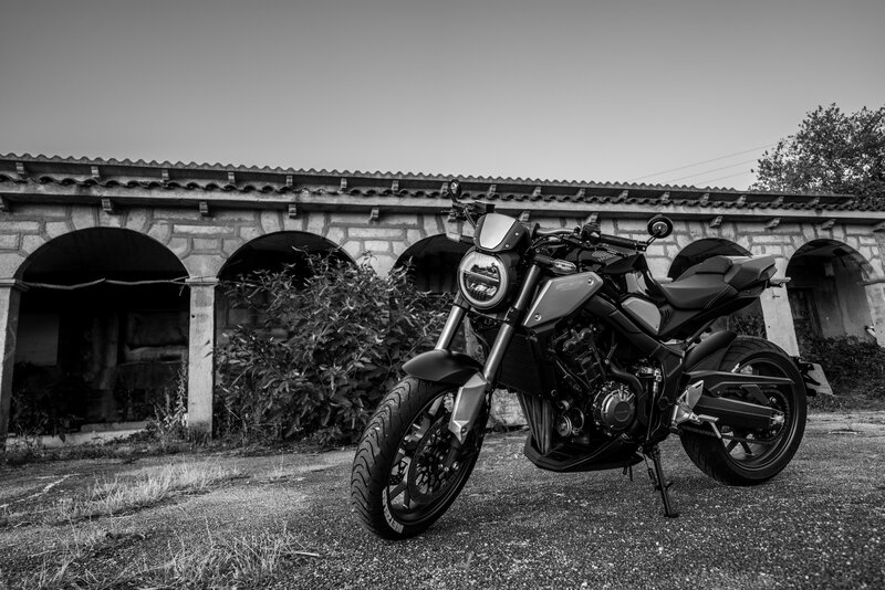 Black Motorcycle — Dramatic, Photograph, Building