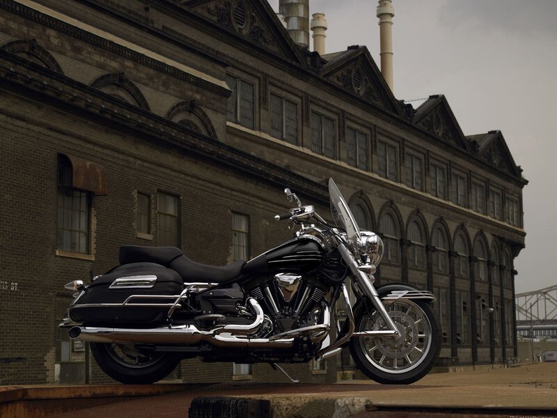 black motorcycle in front of factory