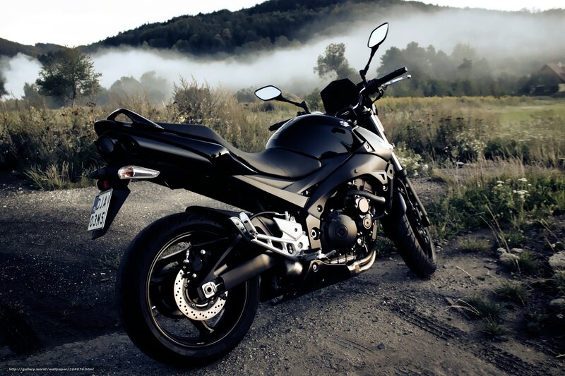 Black motorcycle in misty field