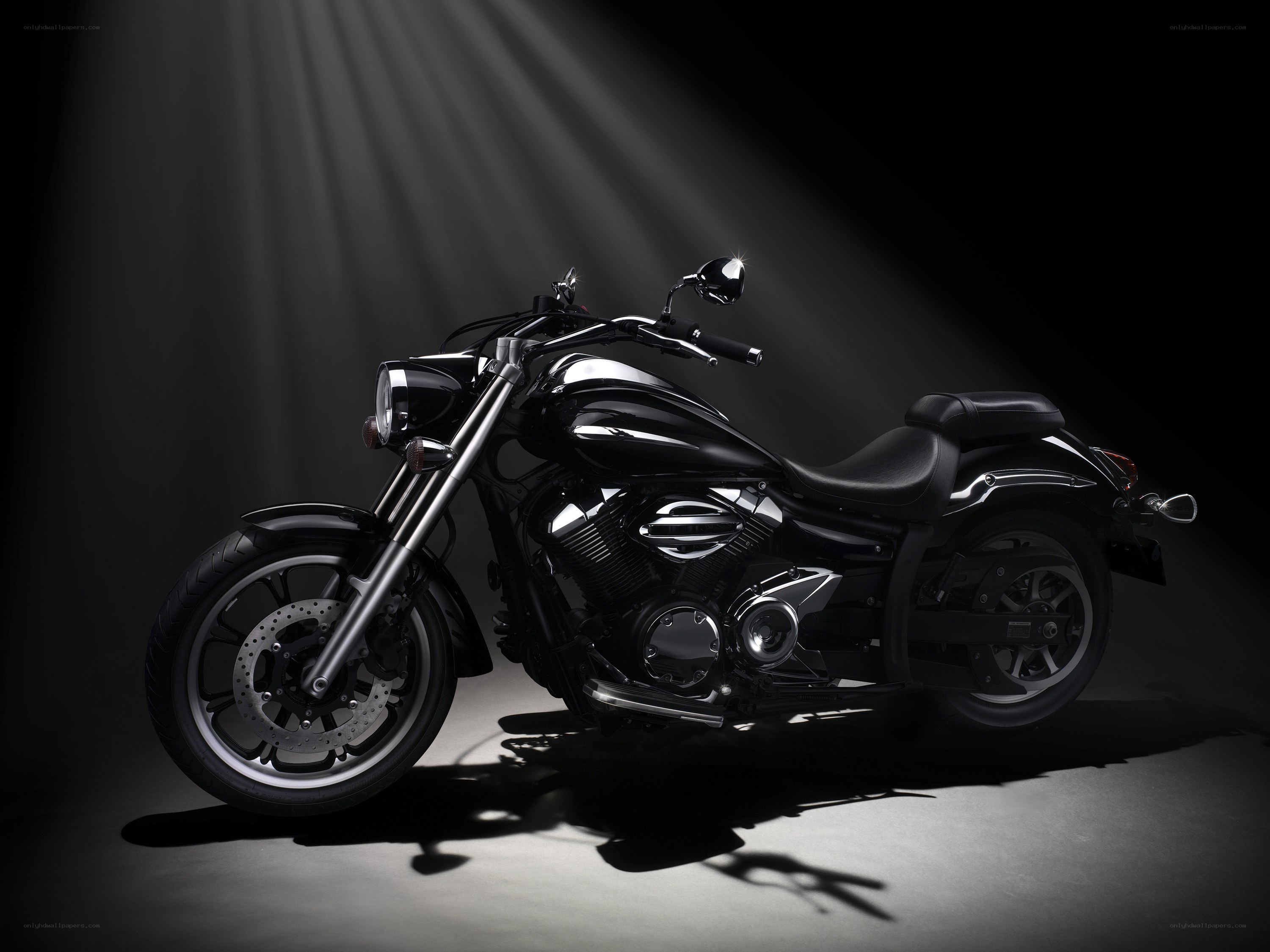 black motorcycle in spotlight