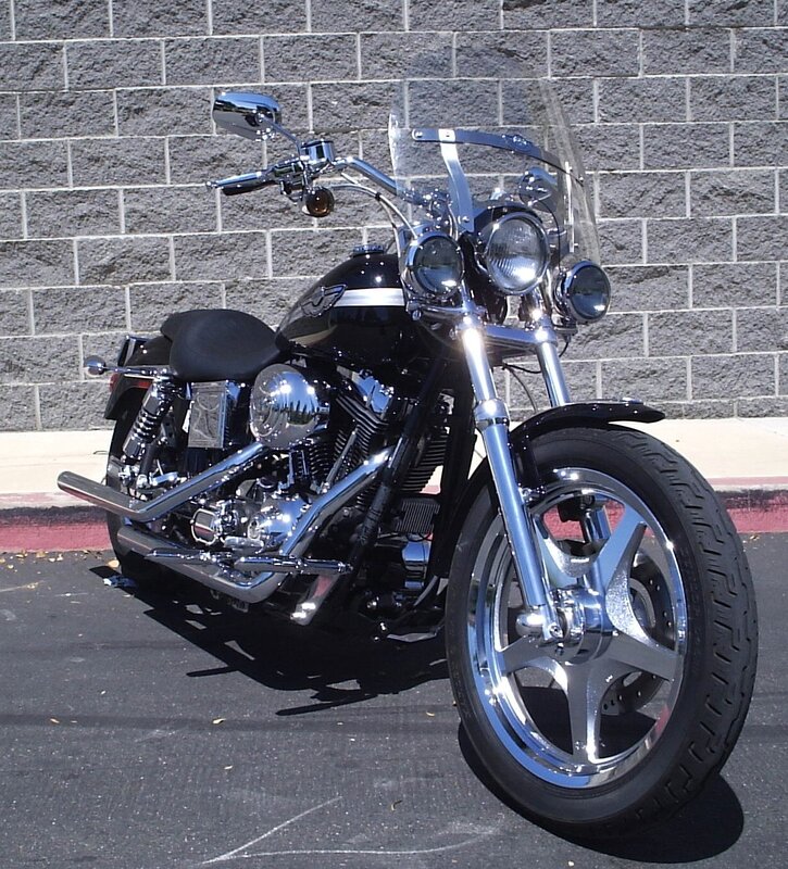 Black Motorcycle — Neutral, Afternoon, Photograph, Wall, Pavement