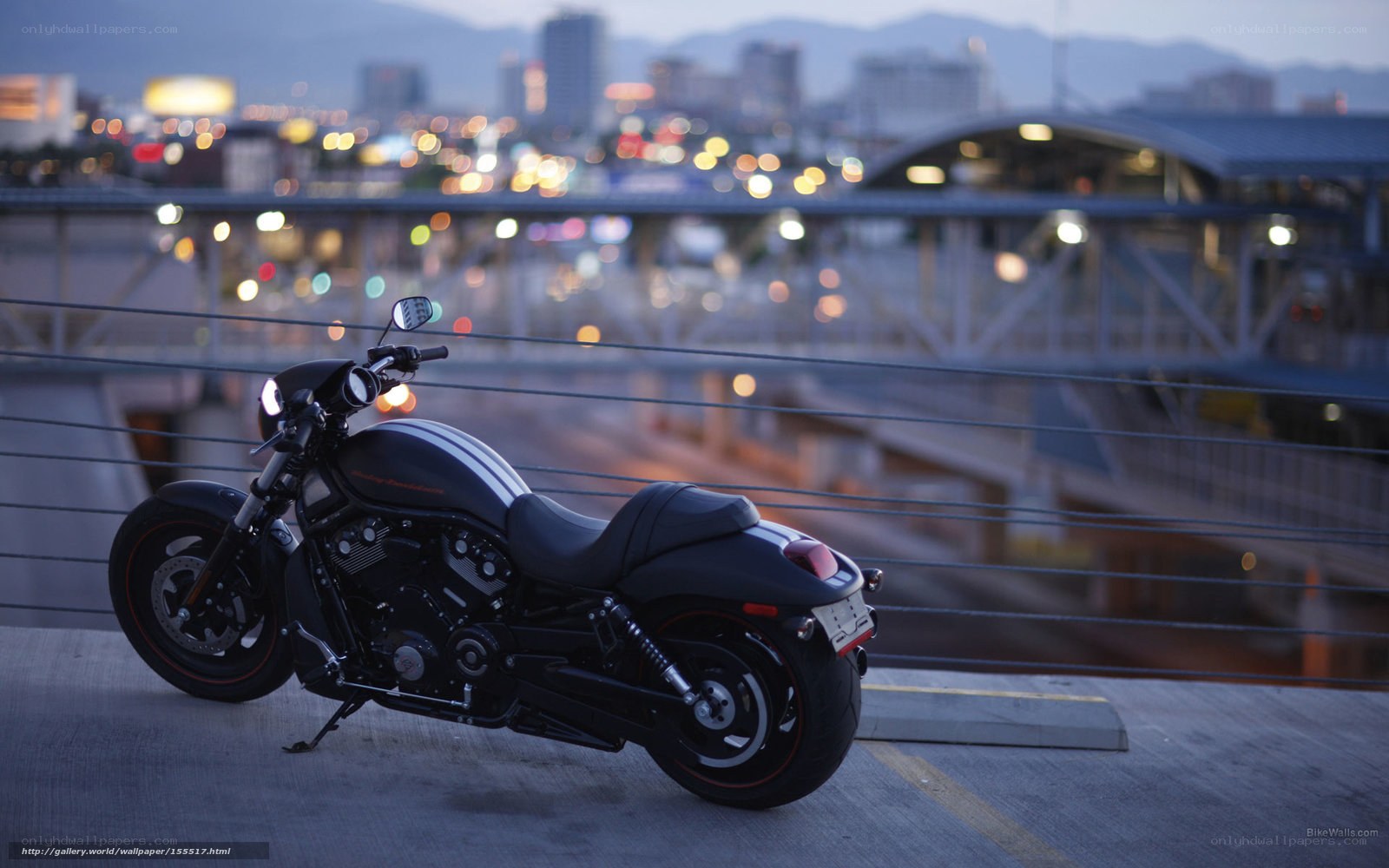 Black motorcycle on bridge at dusk