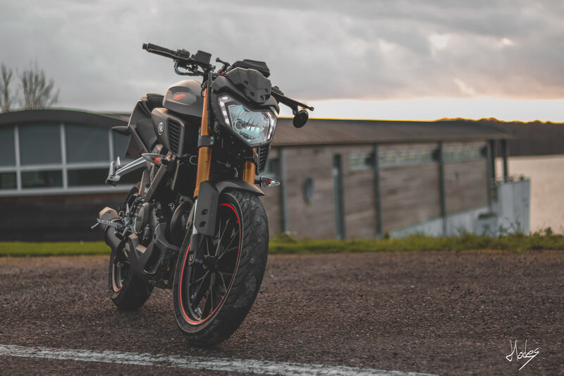 Black Motorcycle on Gravel — Dramatic, Sunset
