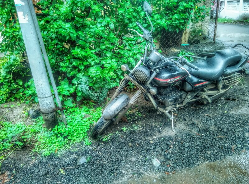Black Motorcycle on Gravel — Green