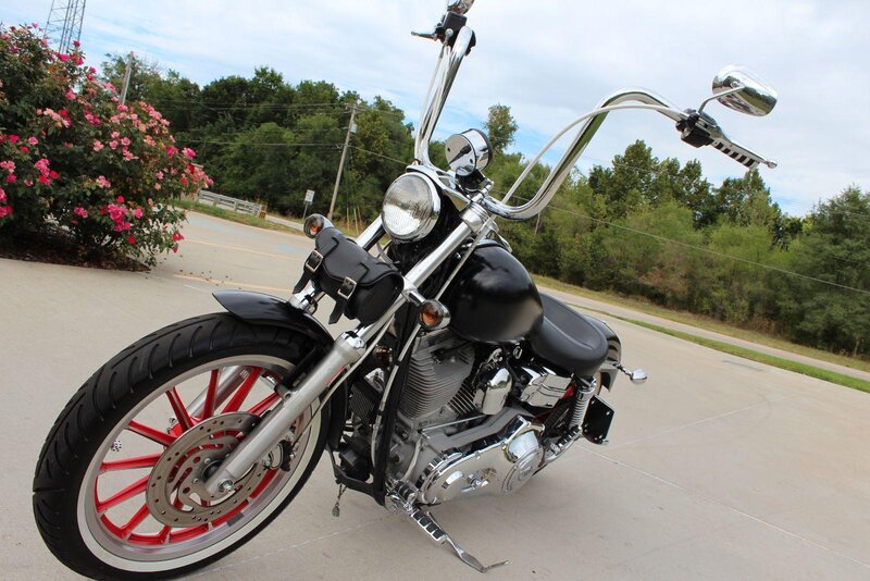 Black Motorcycle on Pavement — Calm, Afternoon, Photograph, Flowers