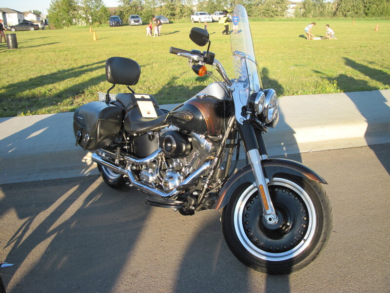 Black Motorcycle on Pavement — Calm, Afternoon
