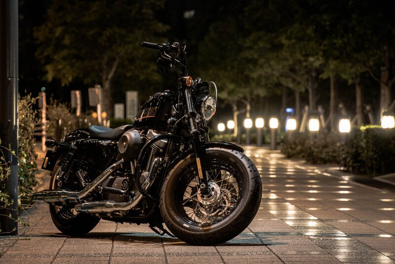 Black Motorcycle on Sidewalk — Dramatic