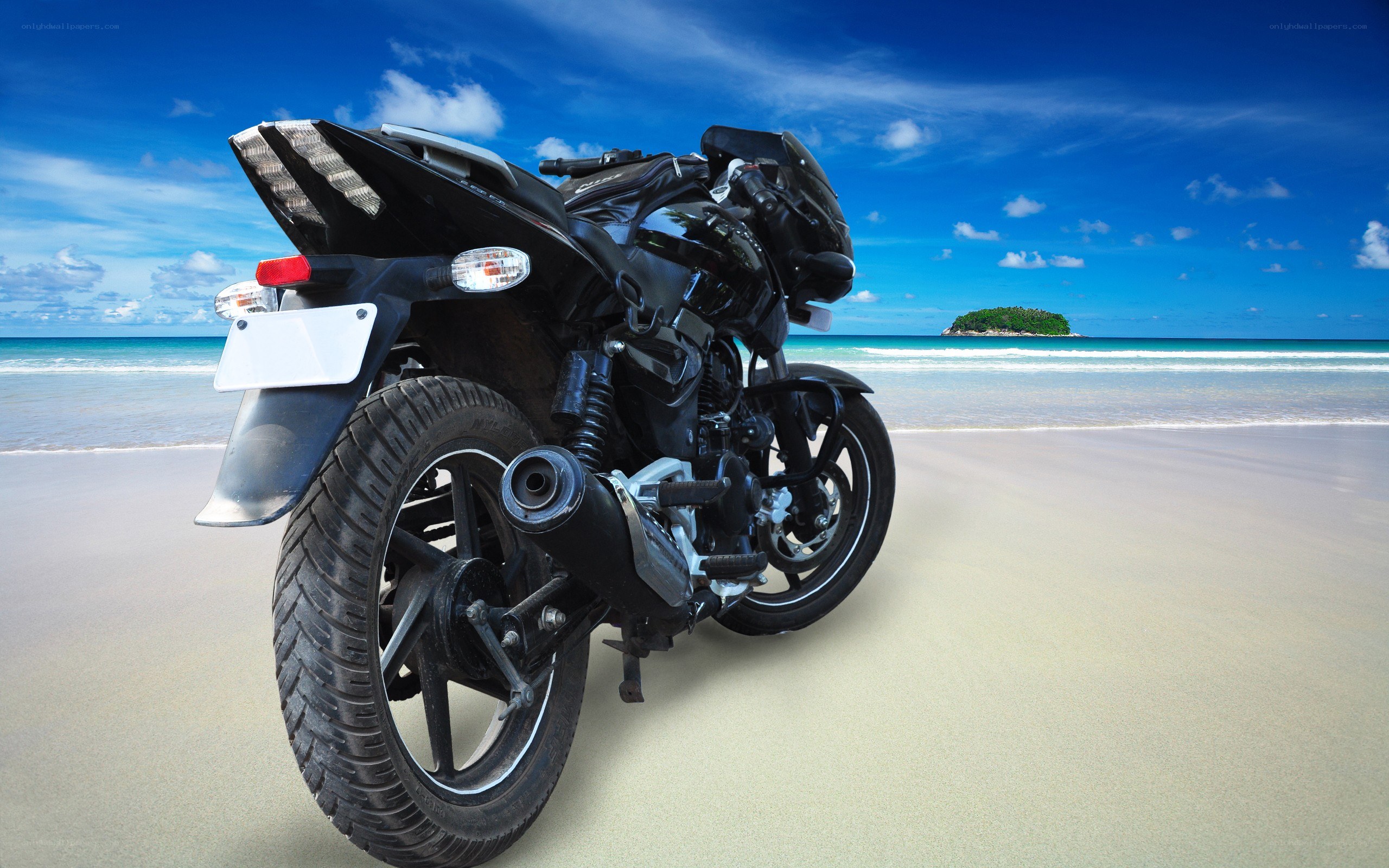 Black motorcycle on tropical beach