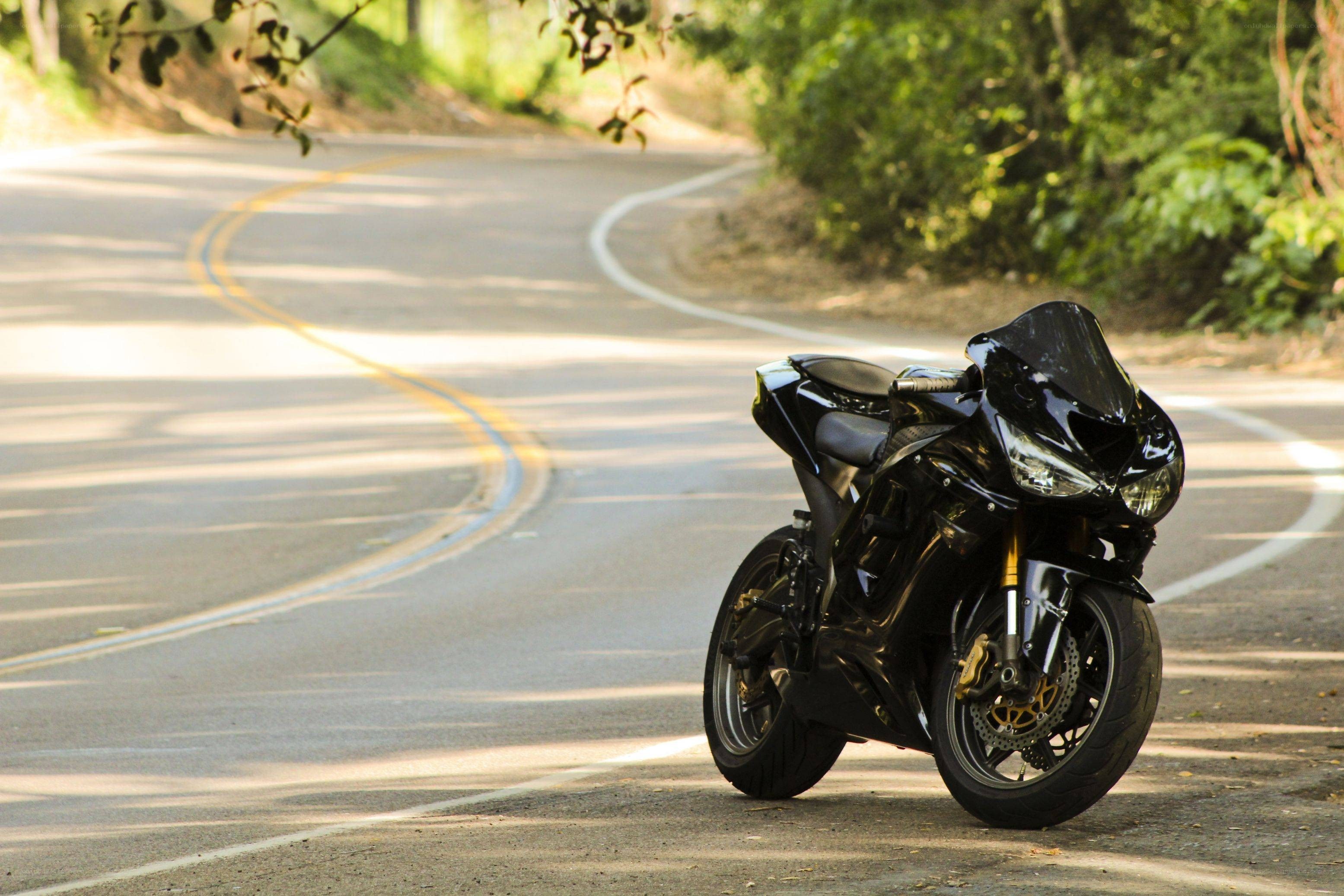Black motorcycle on winding road