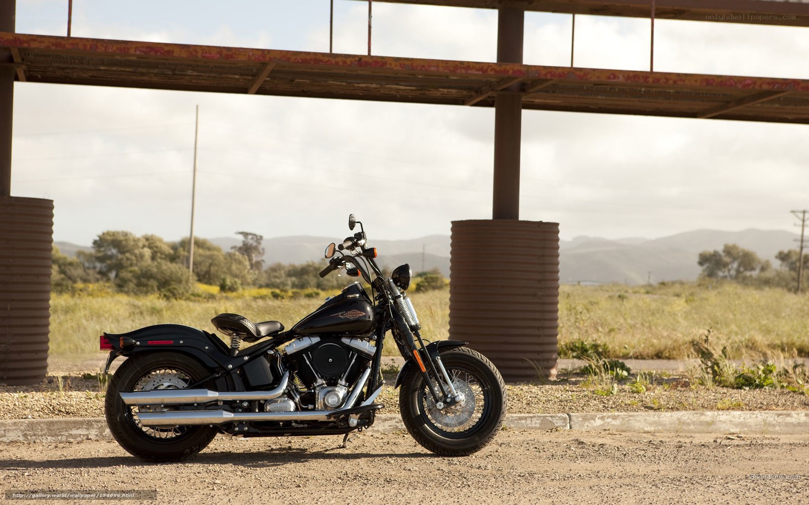 Black motorcycle under bridge