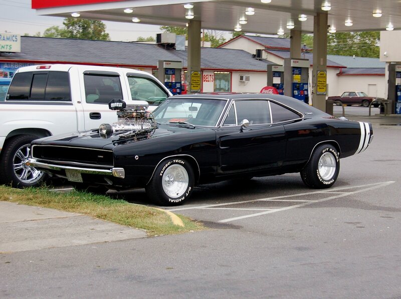 Black muscle car at gas station