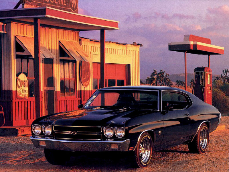 Black muscle car at gas station