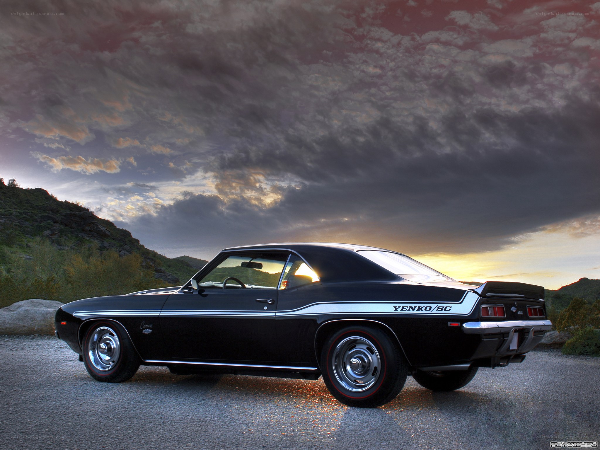 Black muscle car at sunset