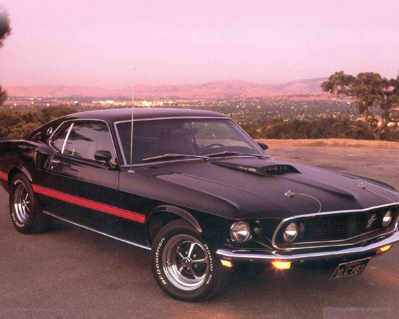 Black muscle car at sunset