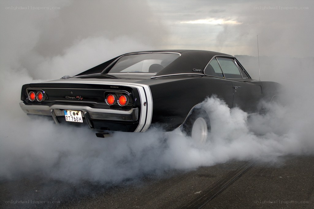 Black muscle car doing burnout