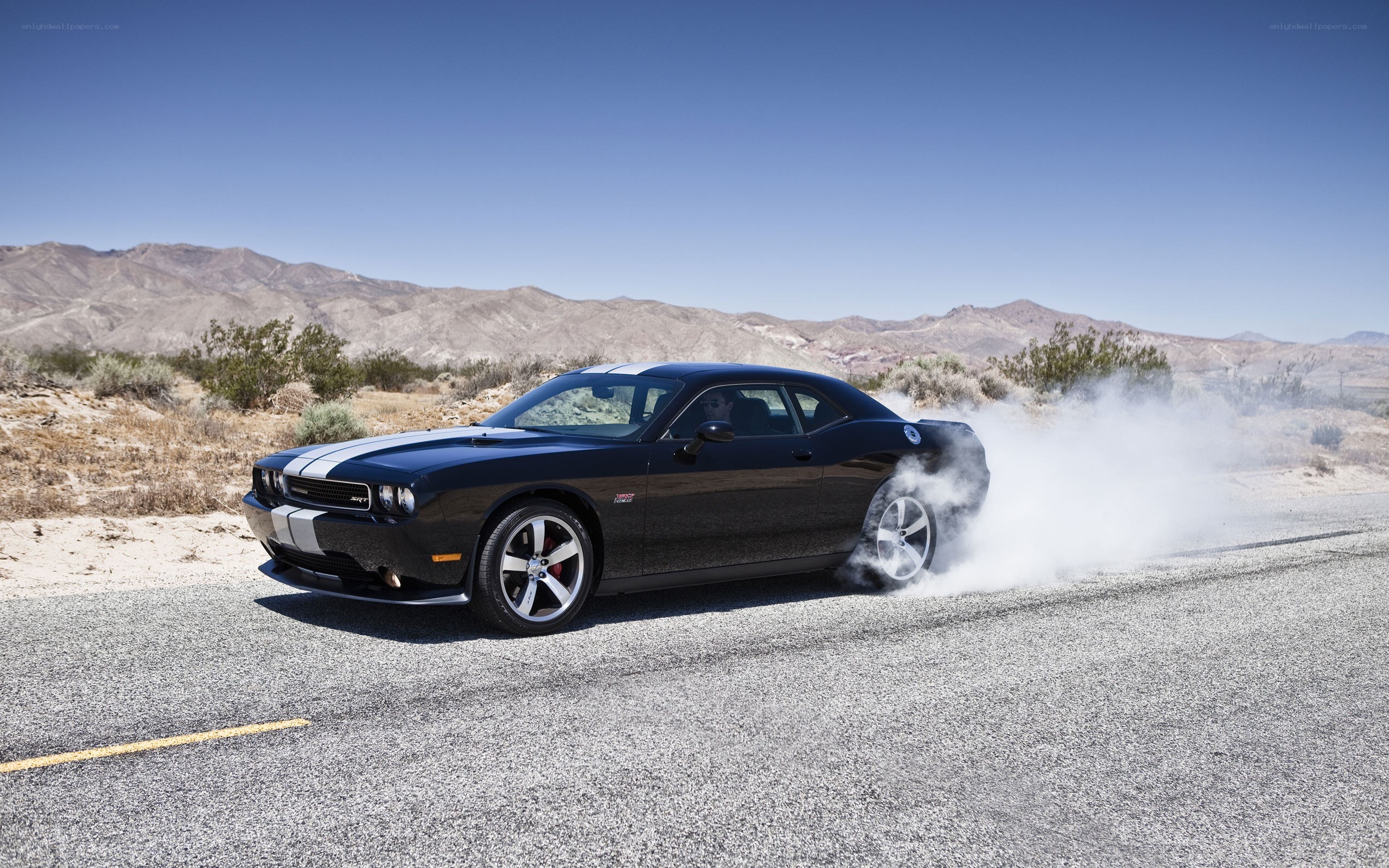 Black muscle car doing burnout