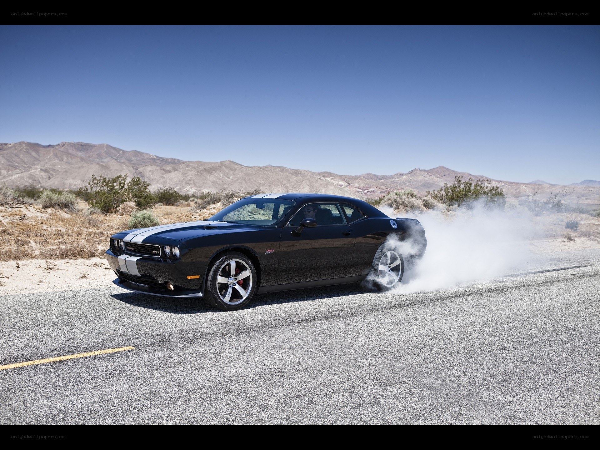 Black muscle car doing burnout