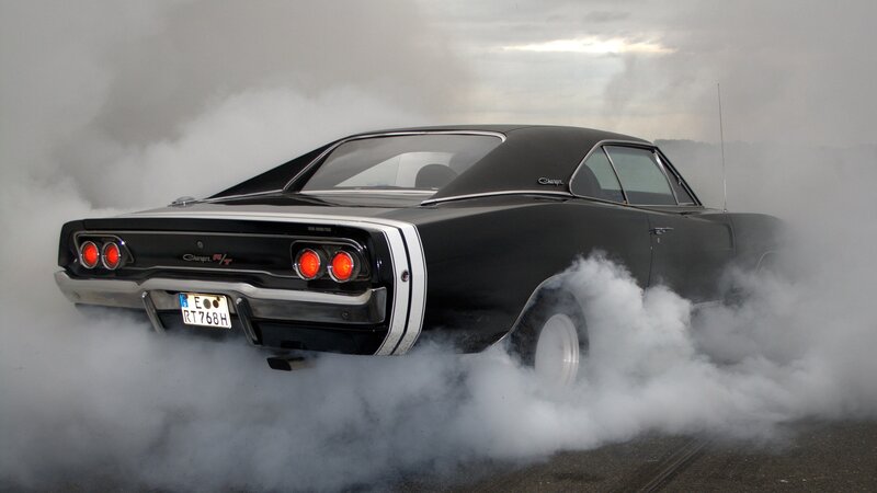 Black muscle car doing burnout