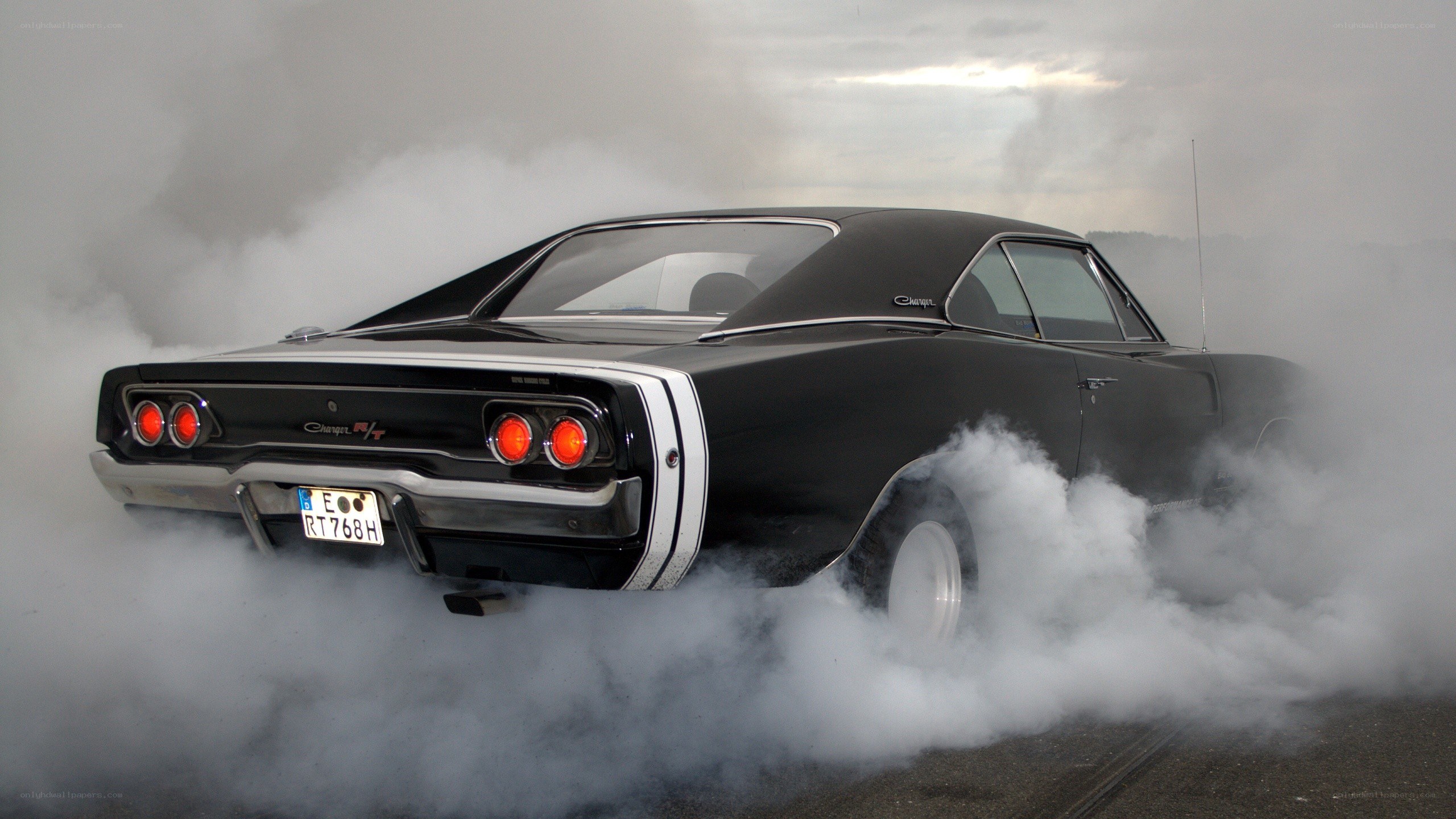 Black muscle car doing burnout
