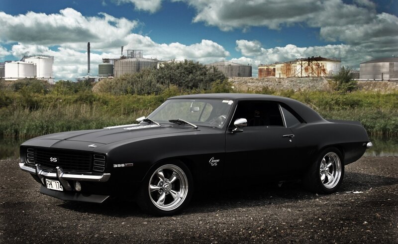 Black Muscle Car — Dramatic, Afternoon, Photograph, Industrial Buildings, Clouds