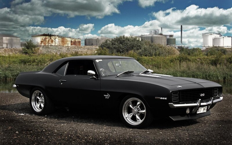 Black Muscle Car — Dramatic, Afternoon, Photograph, Industrial Tanks