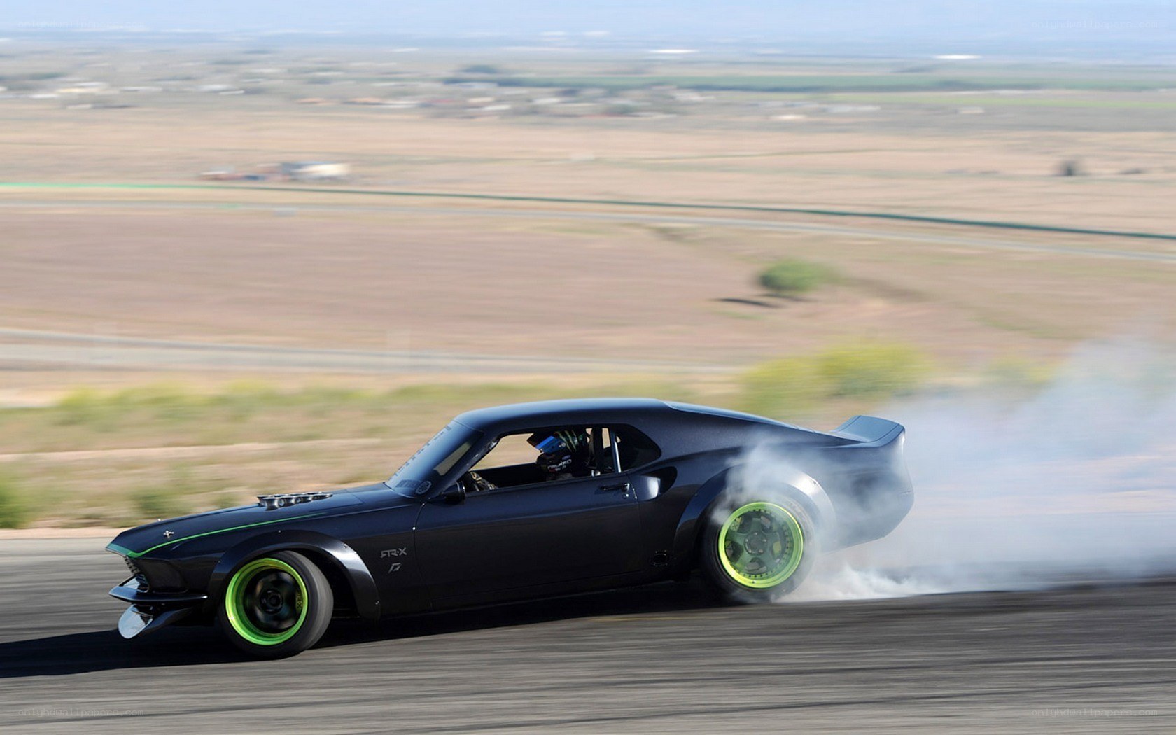Black muscle car drifting