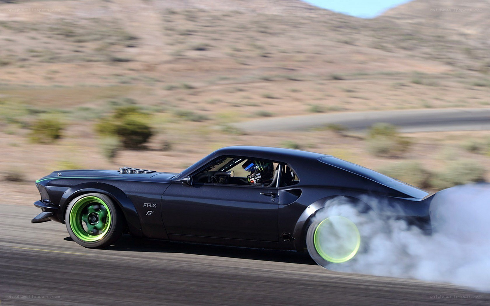 Black muscle car drifting