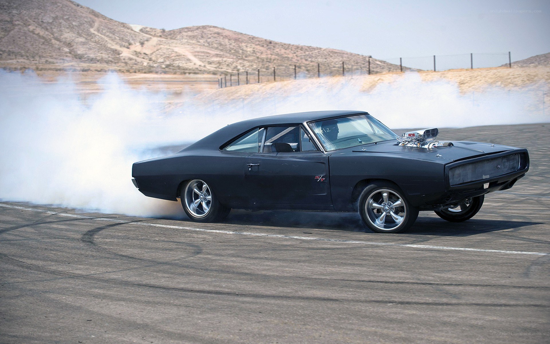 Black muscle car drifting