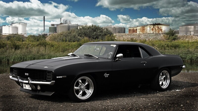 Black muscle car in industrial setting