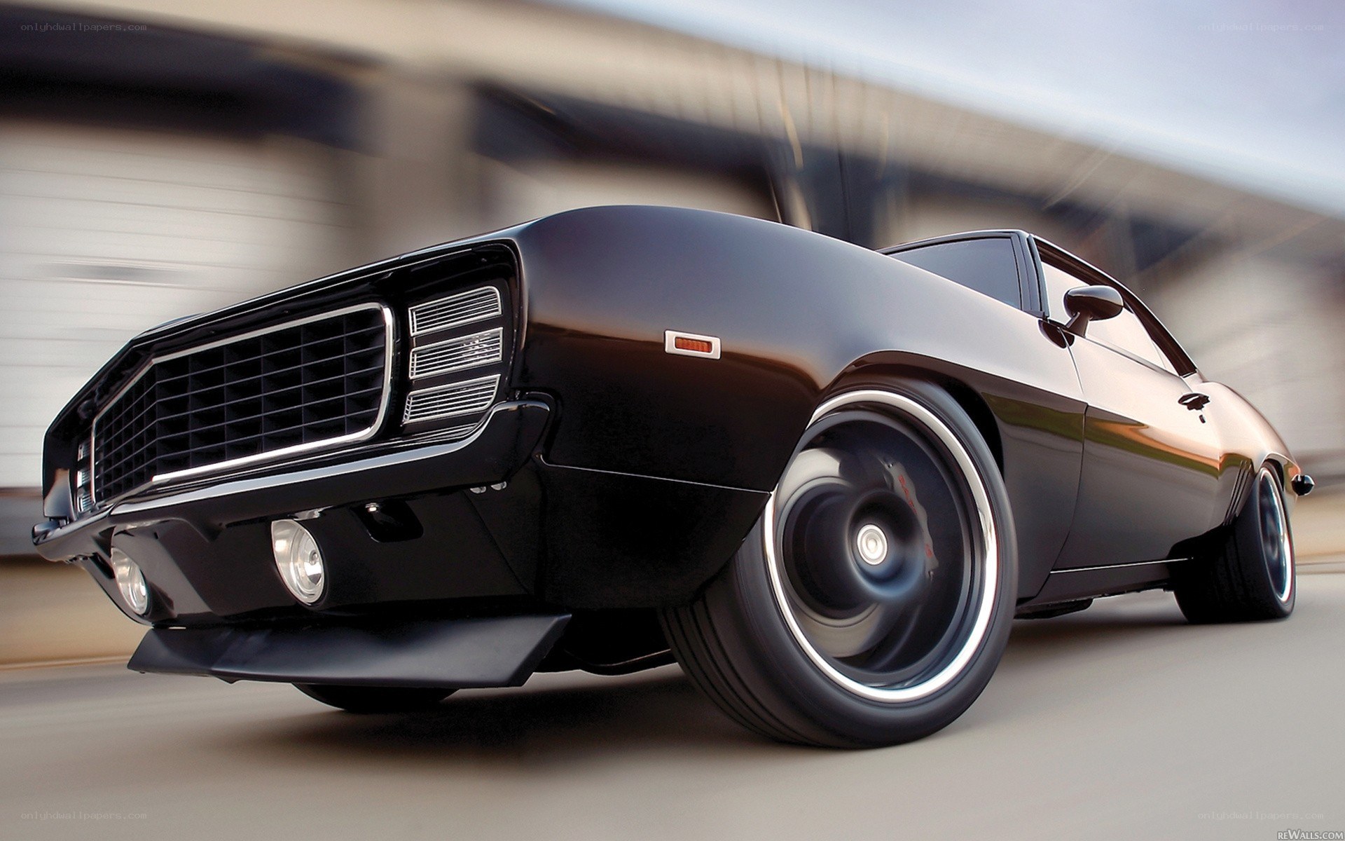 Black muscle car in motion