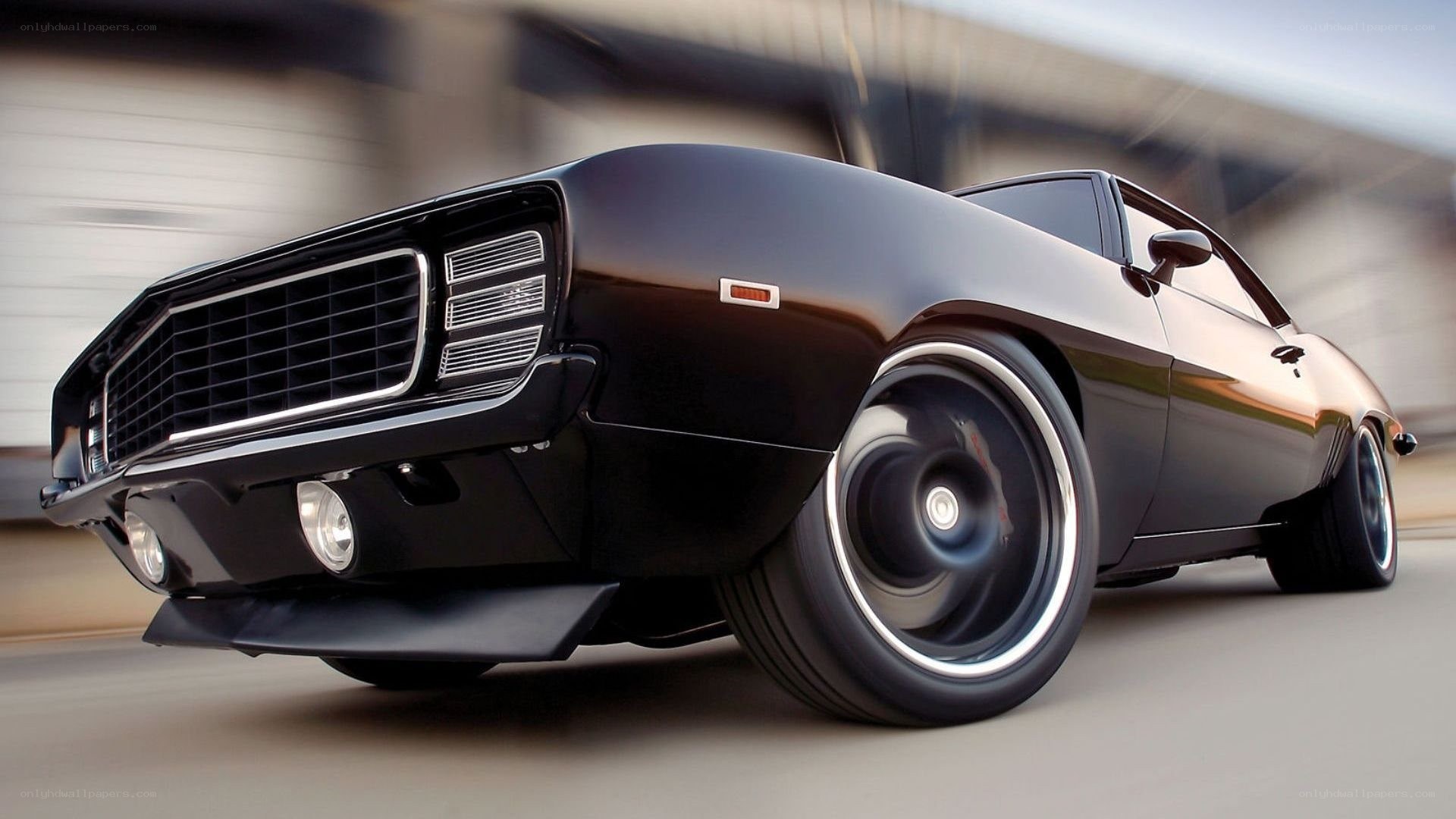 black muscle car in motion