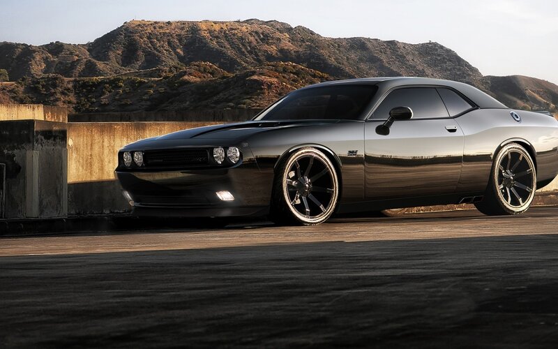 Black muscle car on a bridge